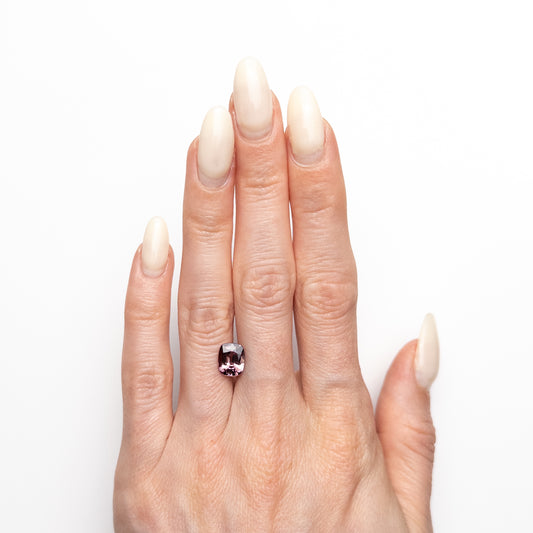2.05ct unheated antique cushion cut brownish-pink sapphire from Madagascar, loose stone held on hand showing colour and cut, before setting