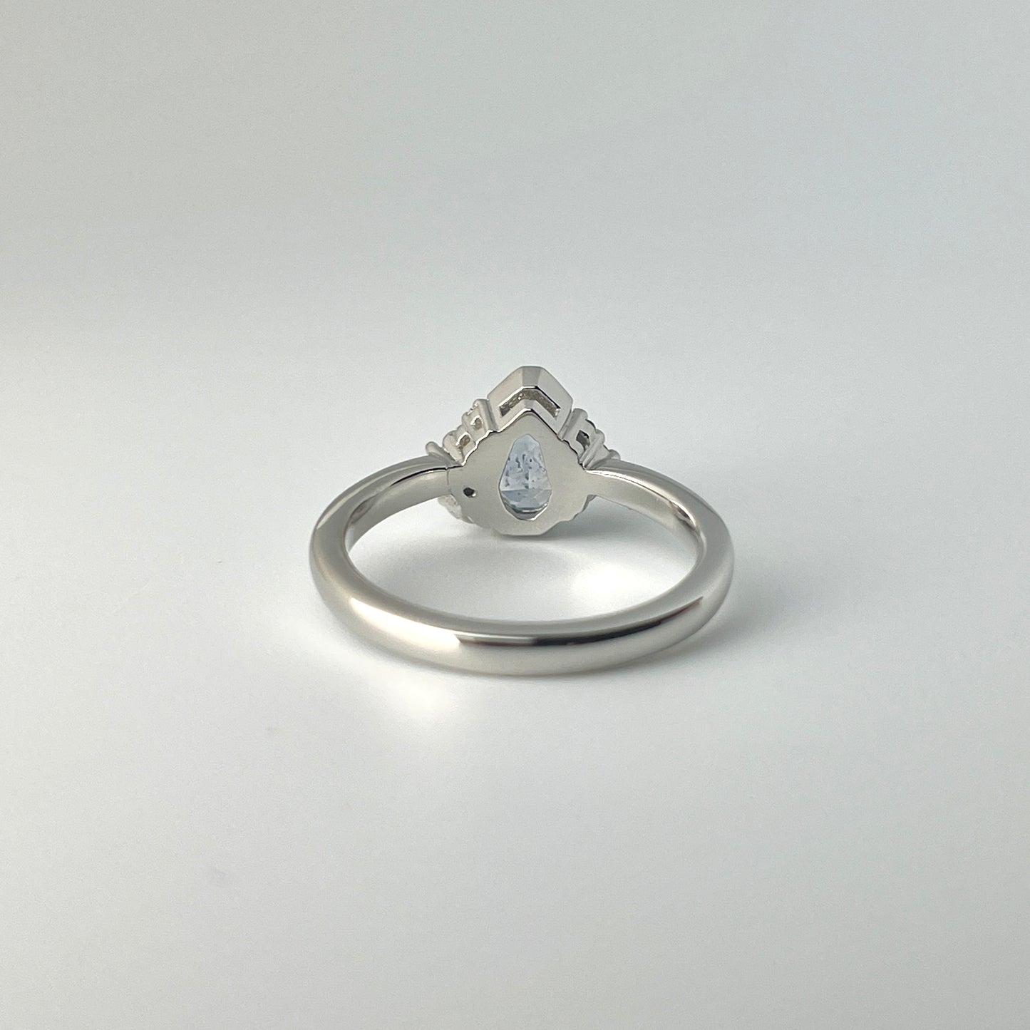 Platinum, light blue sapphire and diamond ring, shown from the bottom to see the opening underneath the gemstone