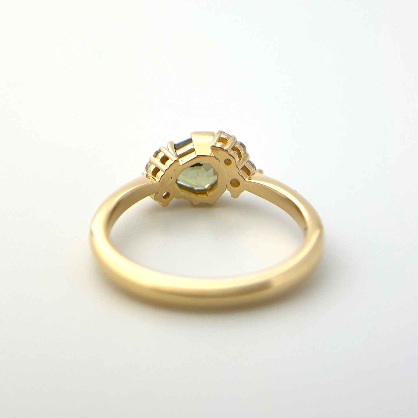 1.27ct unheated geometric trillion cut green Madagascar sapphire and diamond ring in 18k yellow gold, underside view showing setting construction and band detail