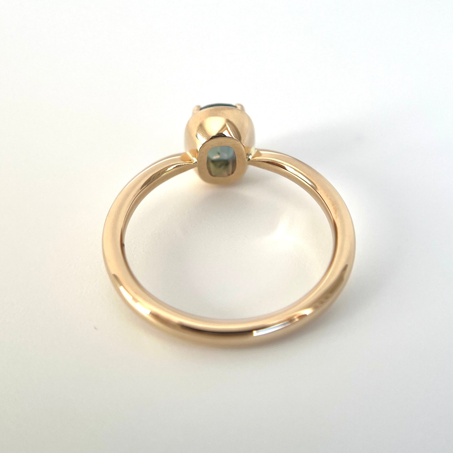 1.10ct elongated cushion cut teal sapphire solitaire ring in 14k yellow gold, underside view showing setting construction and band detail