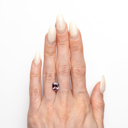 2.05ct unheated antique cushion cut brownish-pink sapphire from Madagascar, loose stone held on hand showing colour and cut, before setting