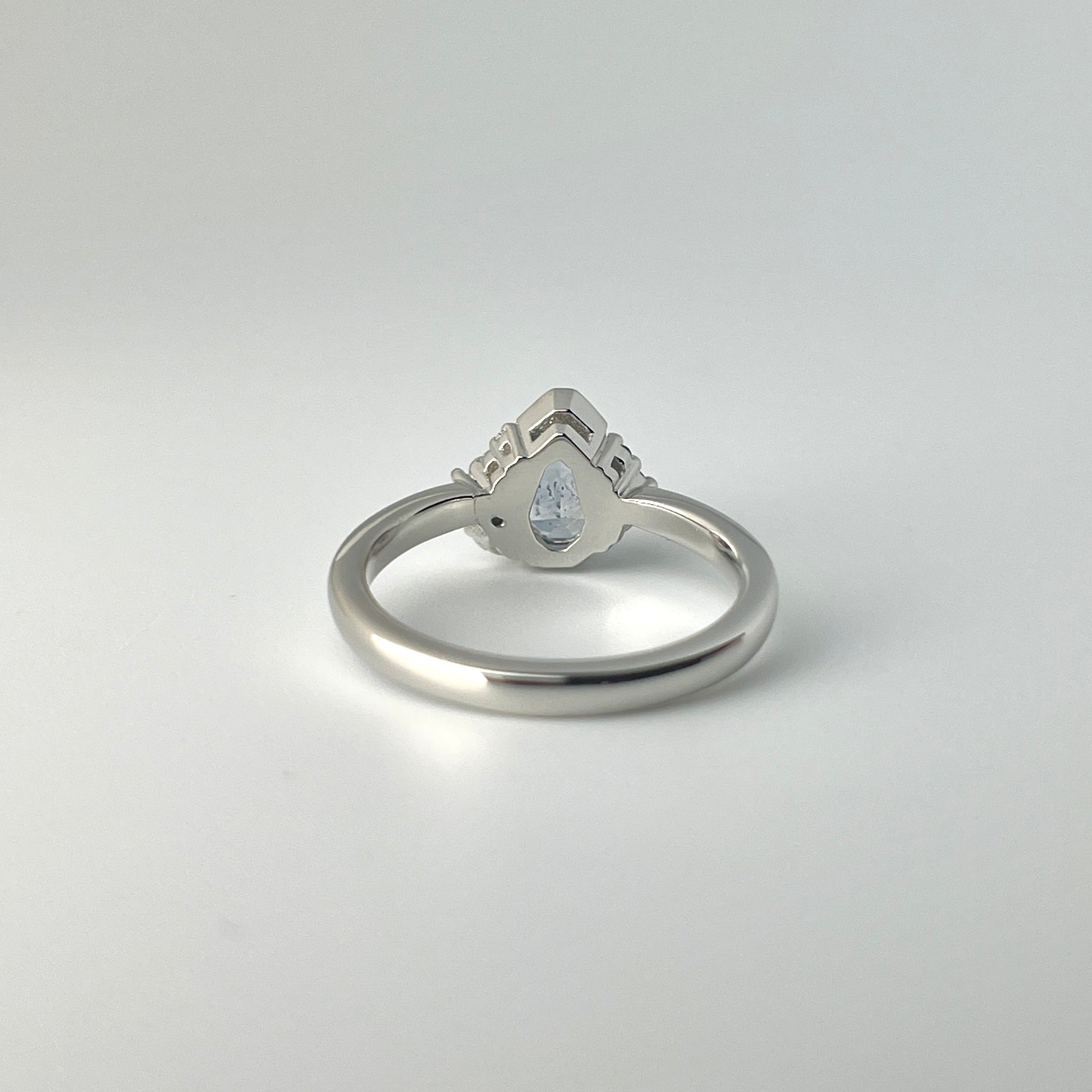 Platinum, light blue sapphire and diamond ring, shown from the bottom to see the opening underneath the gemstone