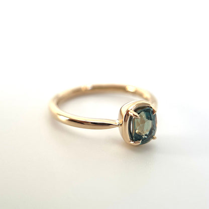 1.10ct elongated cushion cut teal sapphire solitaire ring in 14k yellow gold, side view showing gold frame setting and band profile