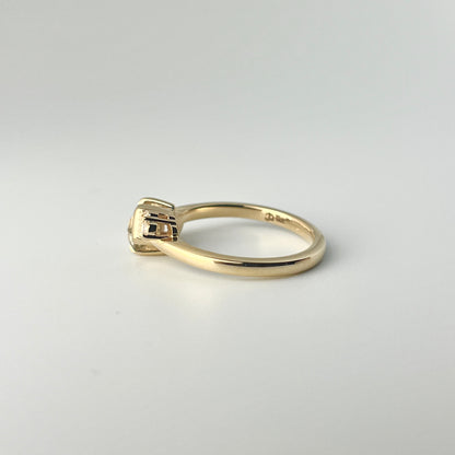Side view of hexagonal sapphire and diamond ring, showing open basket setting to let the light through