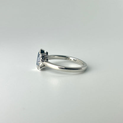 Platinum, blue sapphire and diamond ring, showing the low double gallery basket style head in a side view photo