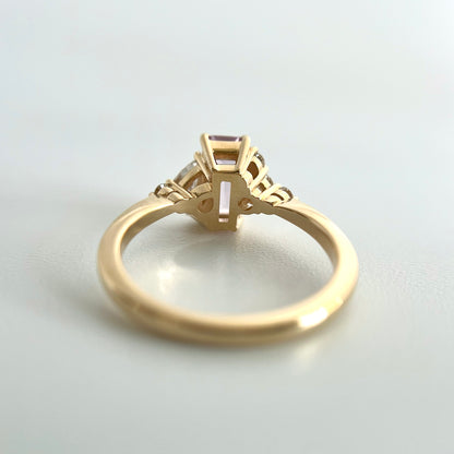 Underside view of a yellow gold ring, showcasing the double gallery detail of each setting. 
