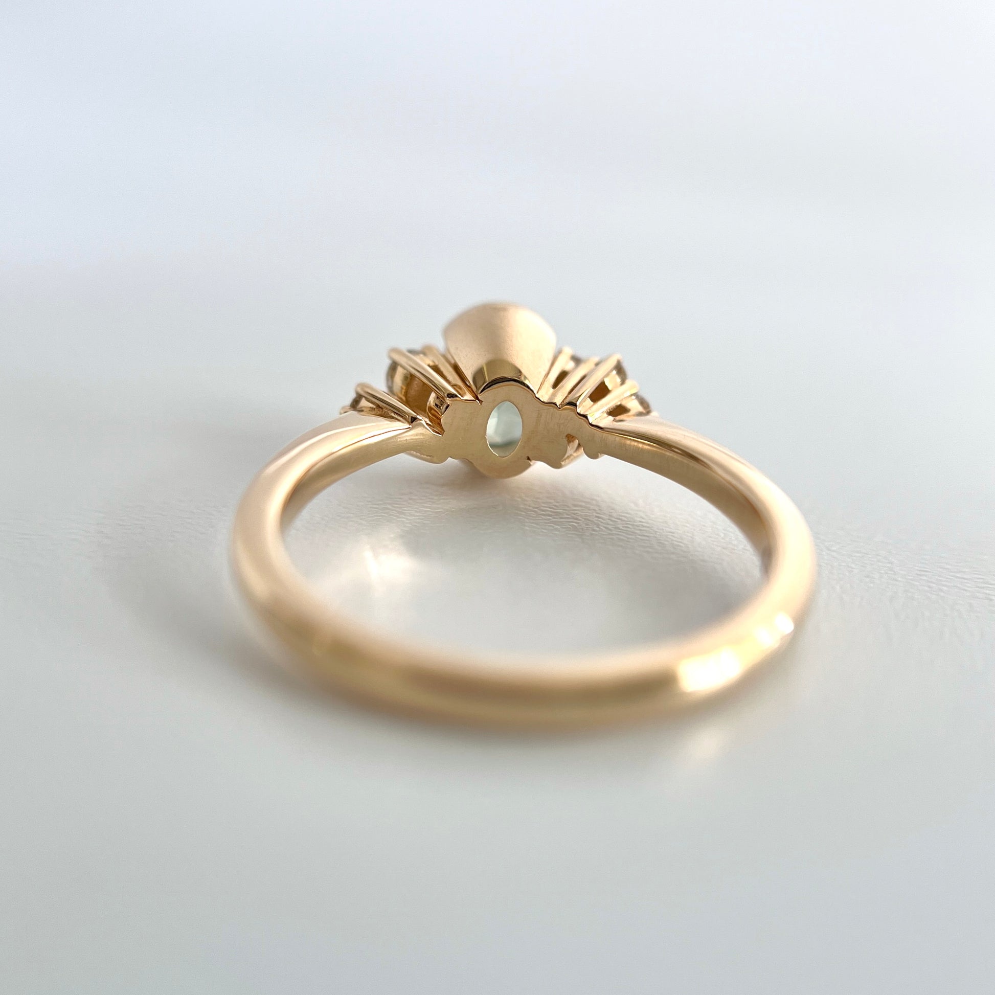 Underside view of a gold ring, to see the half-bwezel and double gallery details. 