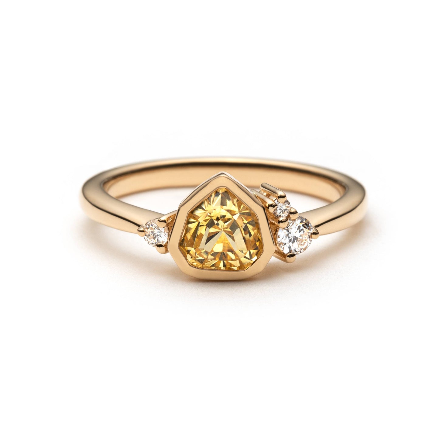 Bright yellow trillion sapphire ring with bezel setting and diamond accents