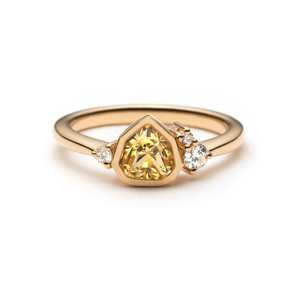 Bright yellow trillion sapphire ring with bezel setting and diamond accents