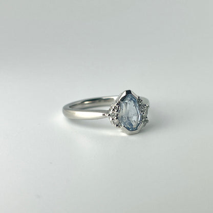 One-of-a-kind light blue sapphire engagement ring in platinum with asymmetrical diamond cluster