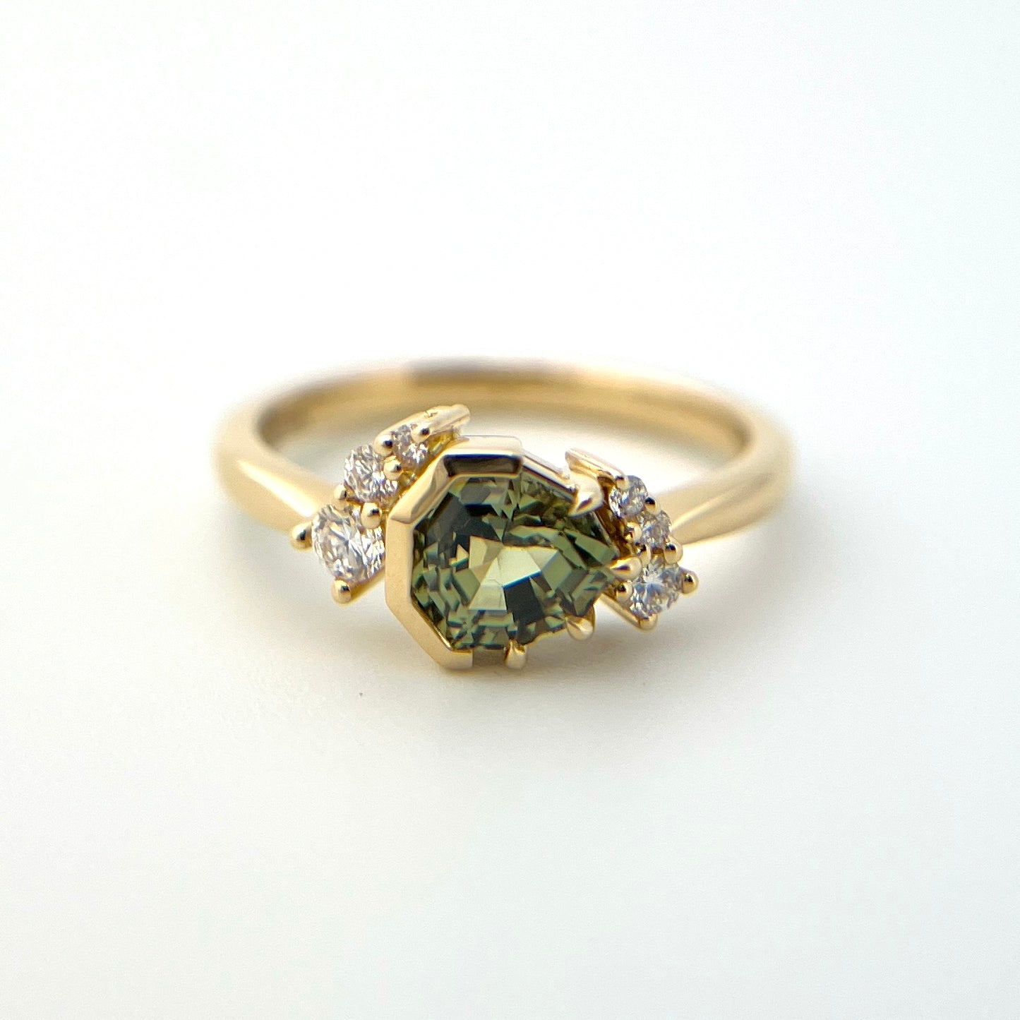 1.27ct unheated geometric trillion cut green Madagascar sapphire and diamond ring in 18k yellow gold, front view showing full setting and diamond accents