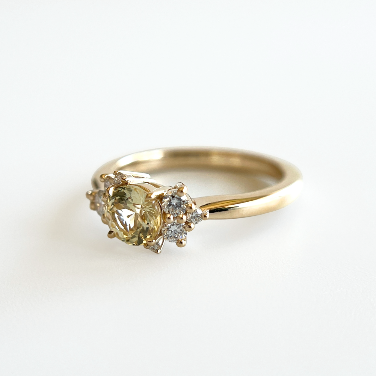 Bague de fiançailles en saphir jaune clair et diamants en or jaune 14k, vue de côté montrant le profil du corps de bague et la hauteur du serti