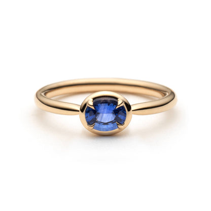 0.61ct unheated oval royal blue sapphire solitaire ring in 14k yellow gold, front view showing gold frame setting