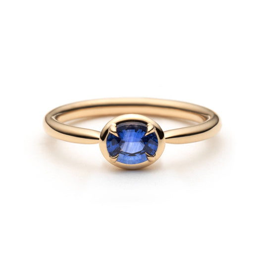 0.61ct unheated oval royal blue sapphire solitaire ring in 14k yellow gold, front view showing gold frame setting