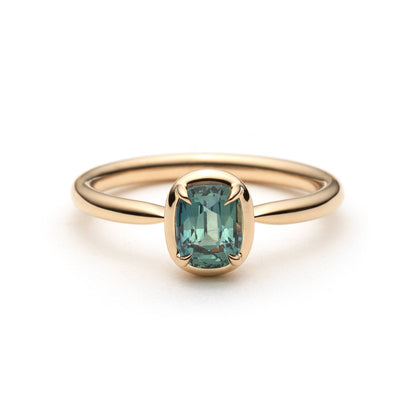 1.10ct elongated cushion cut teal sapphire solitaire ring in 14k yellow gold, front view showing straight band