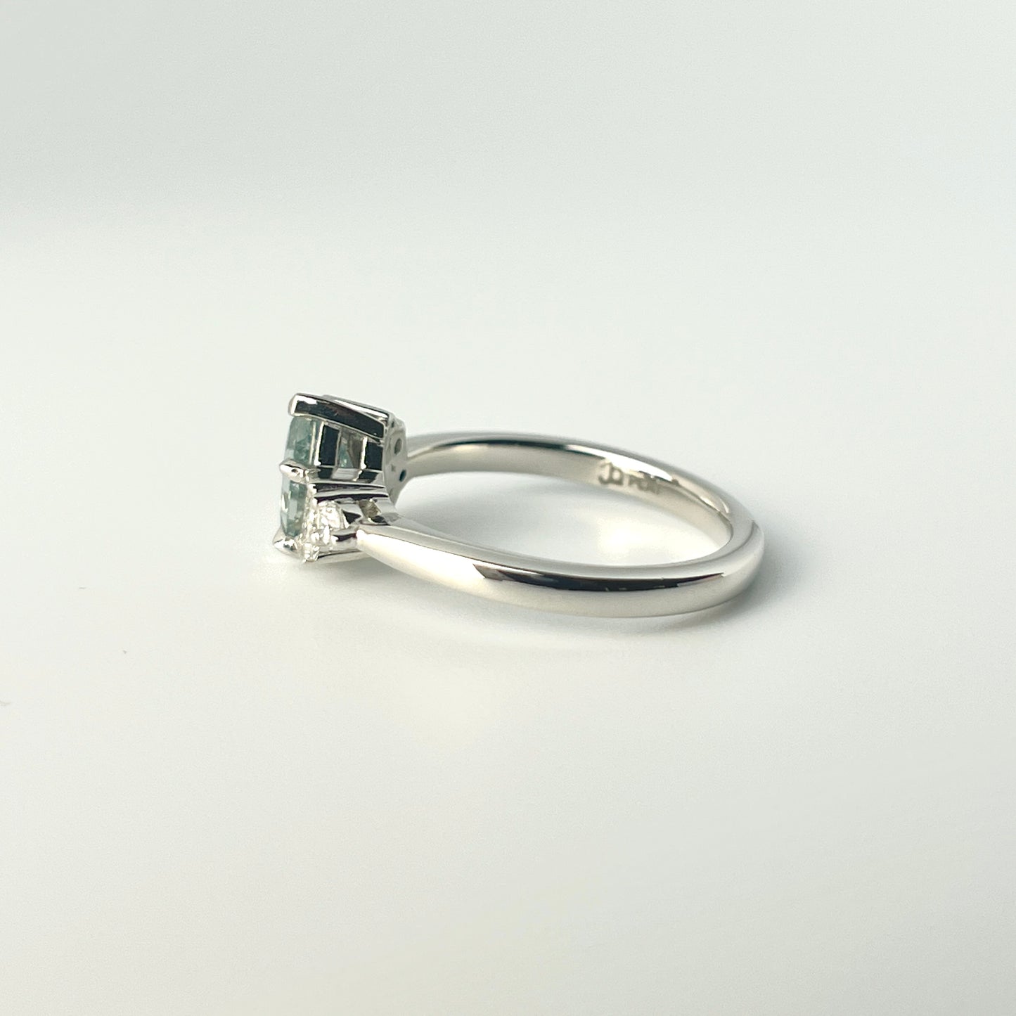 1.27ct step-cut pear shape teal Madagascar sapphire and diamond ring in platinum, profile view showing band width and setting heigh