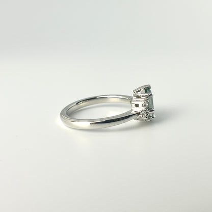 1.27ct step-cut pear shape teal Madagascar sapphire and diamond ring in platinum, side view showing band profile and setting detail