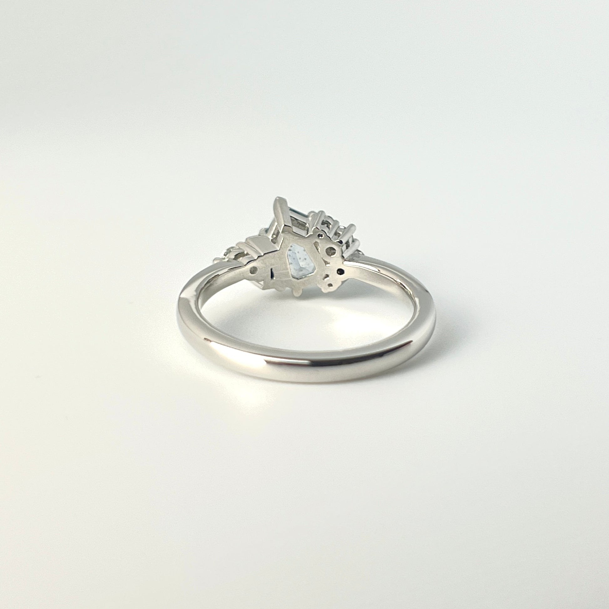 1.27ct step-cut pear shape teal Madagascar sapphire and diamond ring in platinum, underside view showing setting construction and band detail