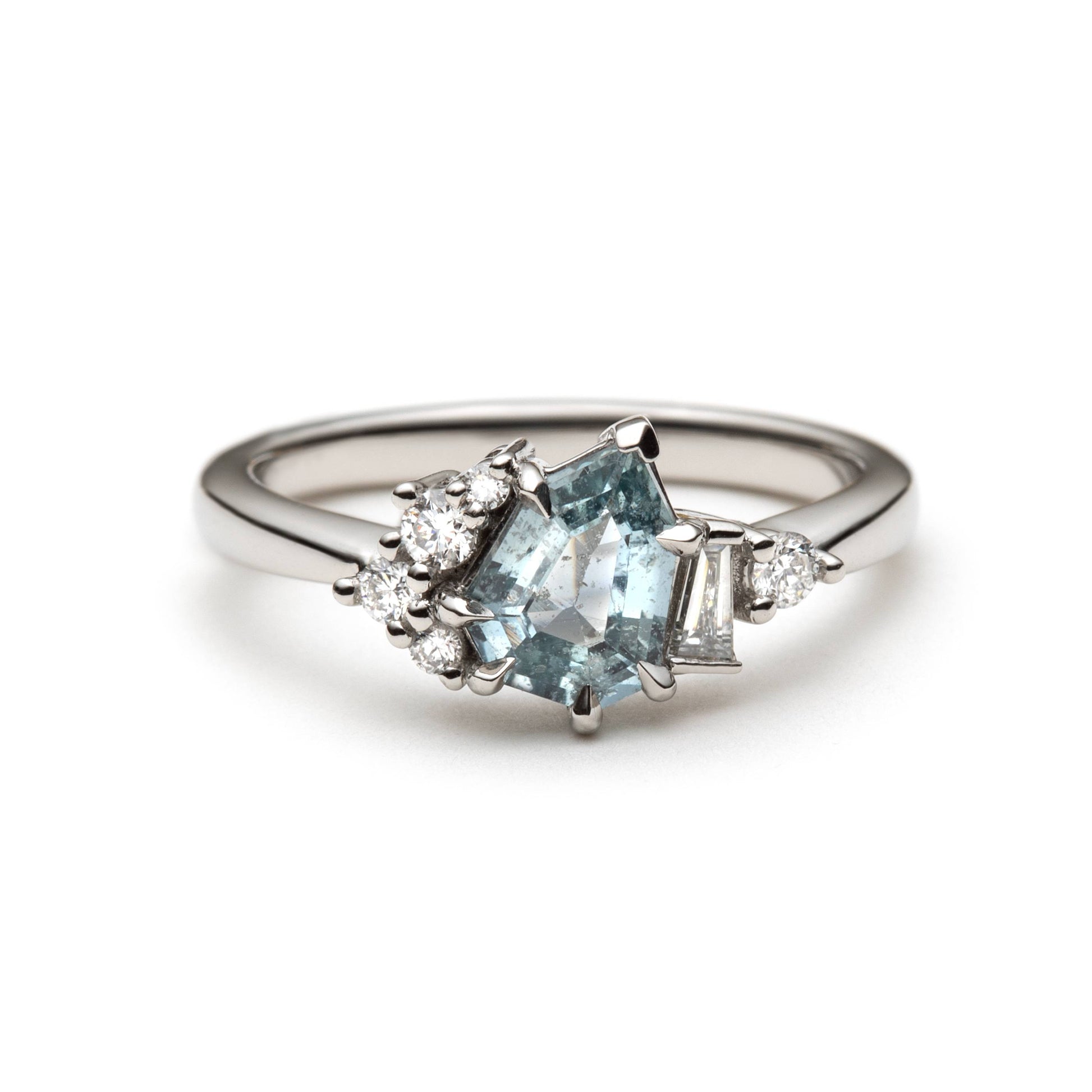 1.27ct step-cut pear shape teal Madagascar sapphire and diamond ring in platinum, front view showing eagle claw setting and diamond accents