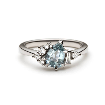 1.27ct step-cut pear shape teal Madagascar sapphire and diamond ring in platinum, front view showing eagle claw setting and diamond accents