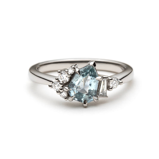 1.27ct step-cut pear shape teal Madagascar sapphire and diamond ring in platinum, front view showing eagle claw setting and diamond accents