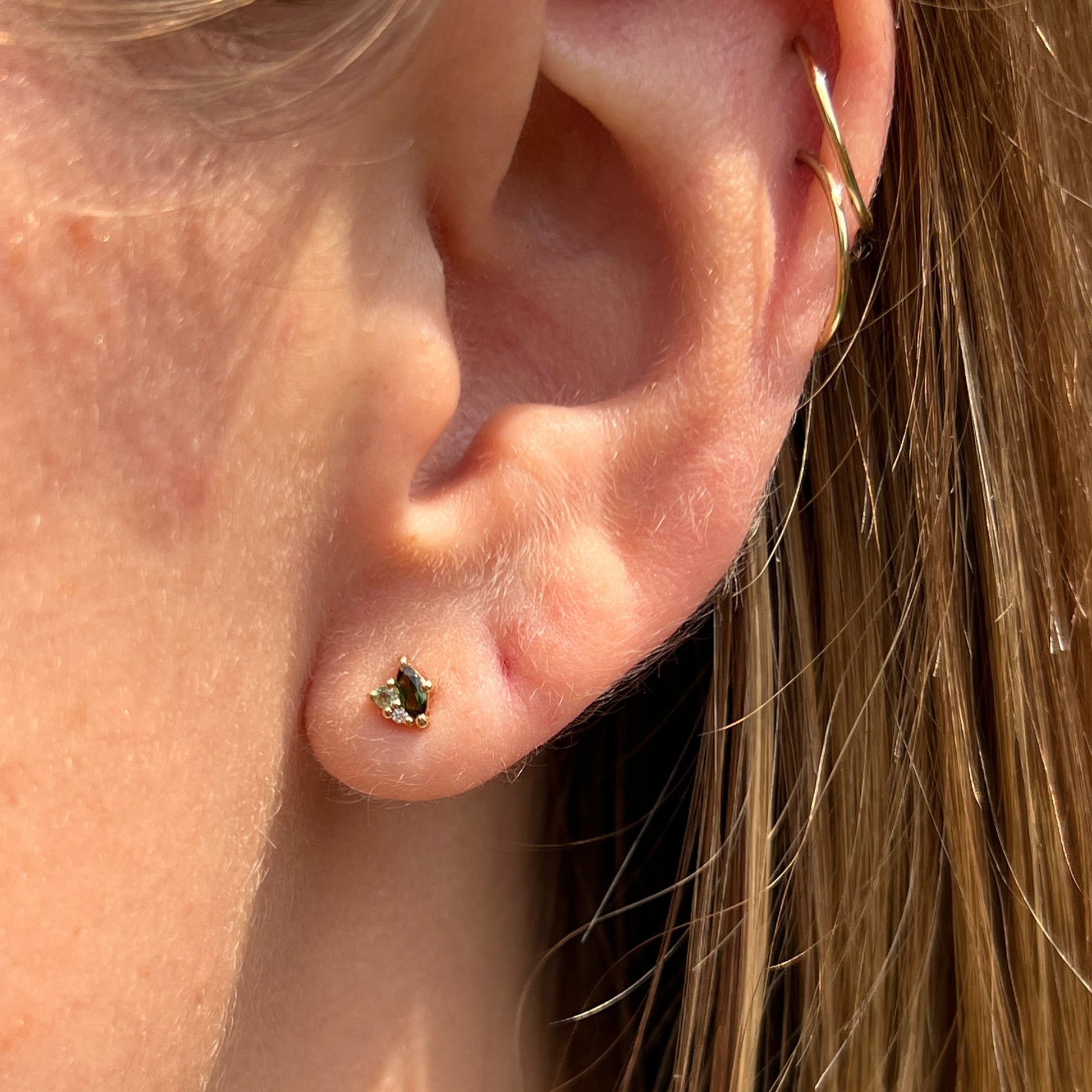 Cluster stud earrings made in yellow gold set with marquise shaped green tourmalines, peridots and diamonds.