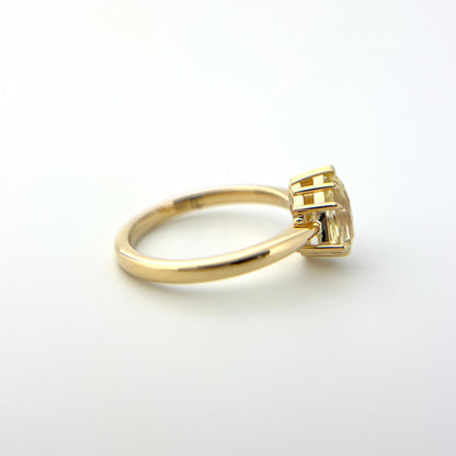 1.07ct shield cut light yellow Sri Lankan sapphire and diamond ring in 18k yellow gold, profile view showing band width and setting height