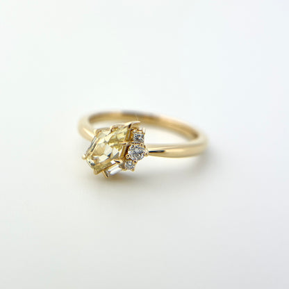 1.07ct shield cut light yellow Sri Lankan sapphire and diamond ring in 18k yellow gold, side view showing band profile and diamond accent detail