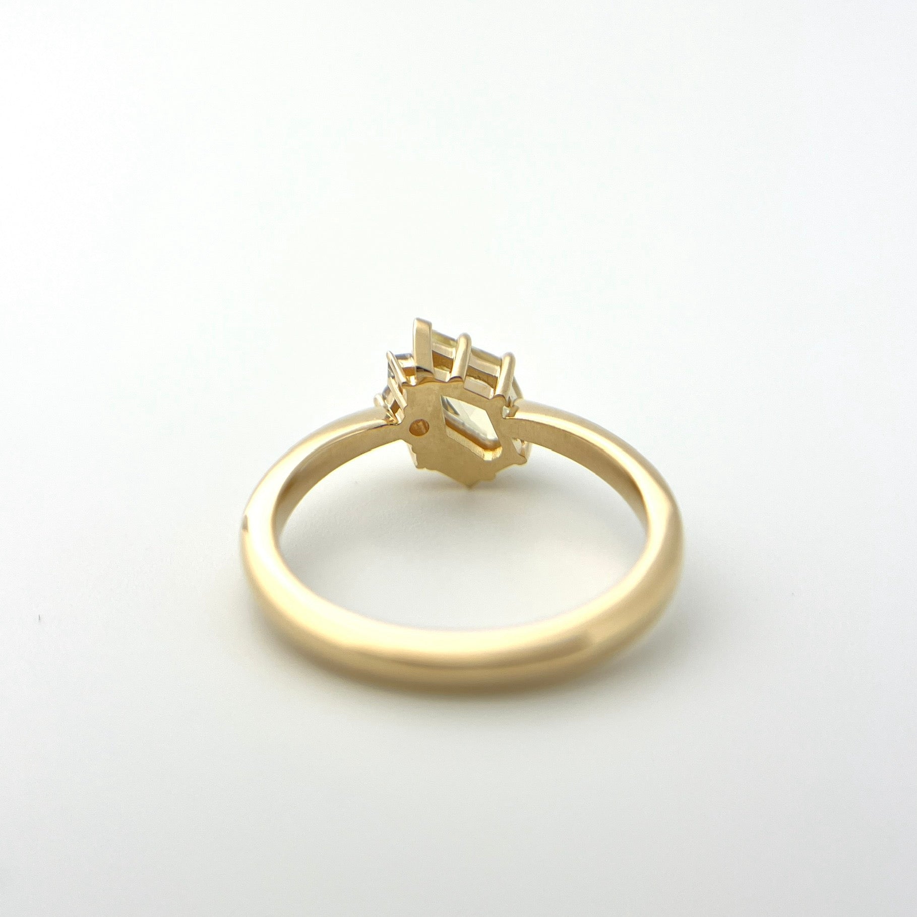 1.07ct shield cut light yellow Sri Lankan sapphire and diamond ring in 18k yellow gold, underside view showing setting construction and band detail