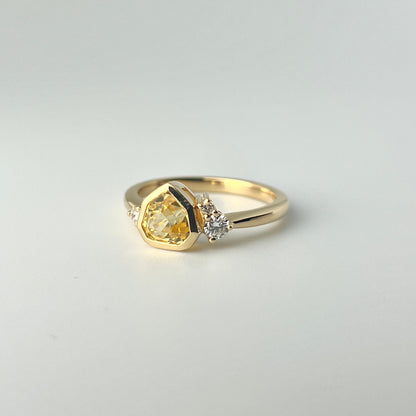 1.18ct mixed-cut trillion shaped bright yellow Sri Lankan sapphire and diamond ring in 18k yellow gold, front angled view showing bezel setting and diamond accents