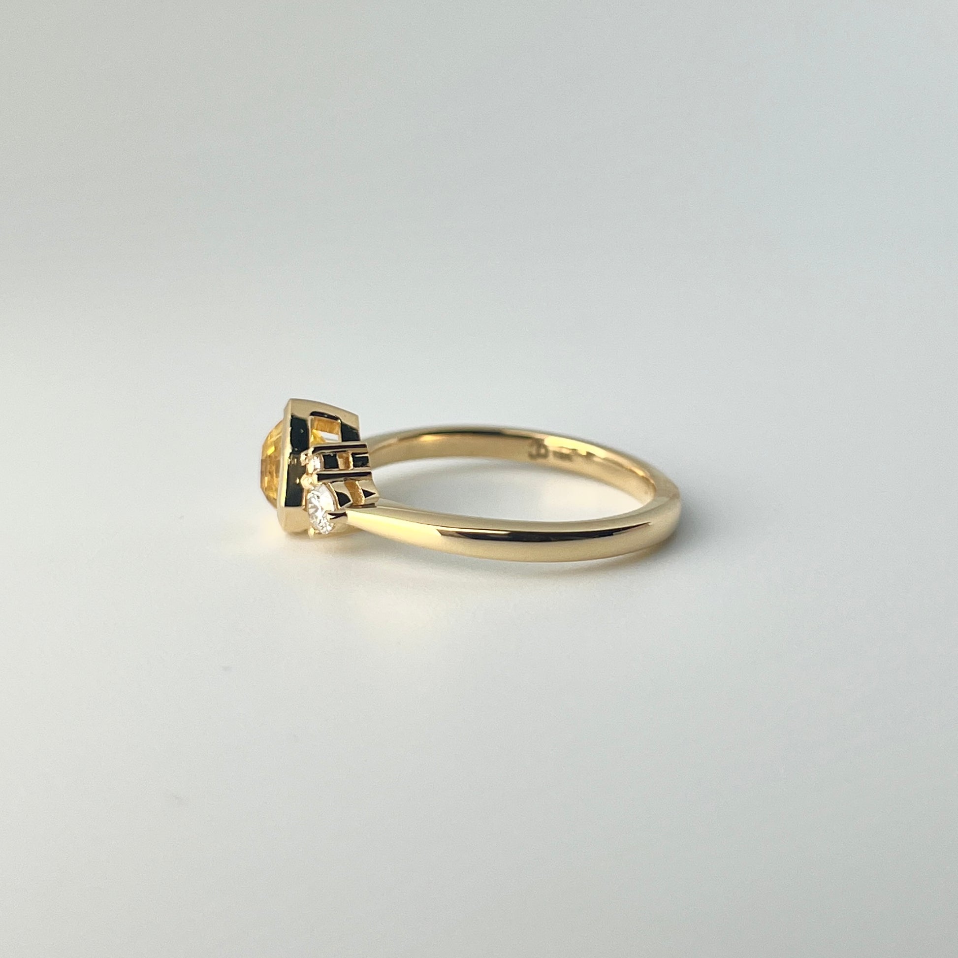 1.18ct mixed-cut trillion shaped bright yellow Sri Lankan sapphire and diamond ring in 18k yellow gold, profile view showing band width and setting height